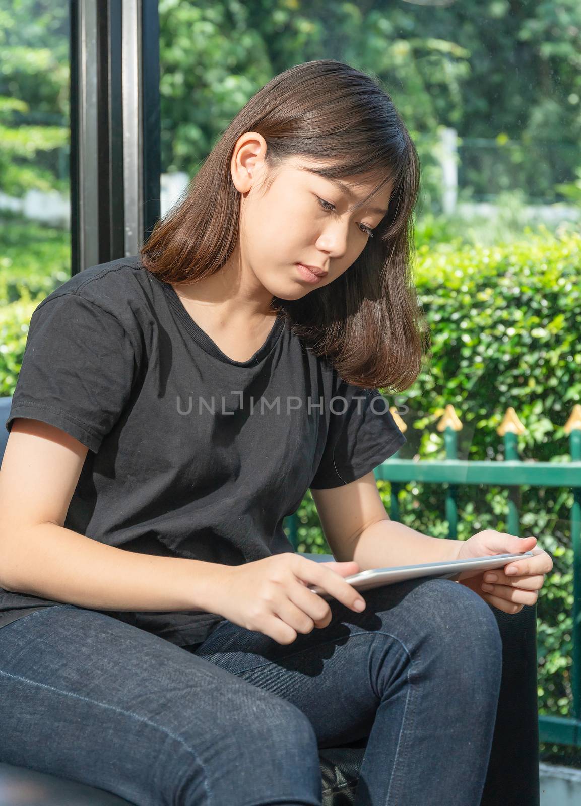 Teenage studying online from digital tablet at home by stoonn