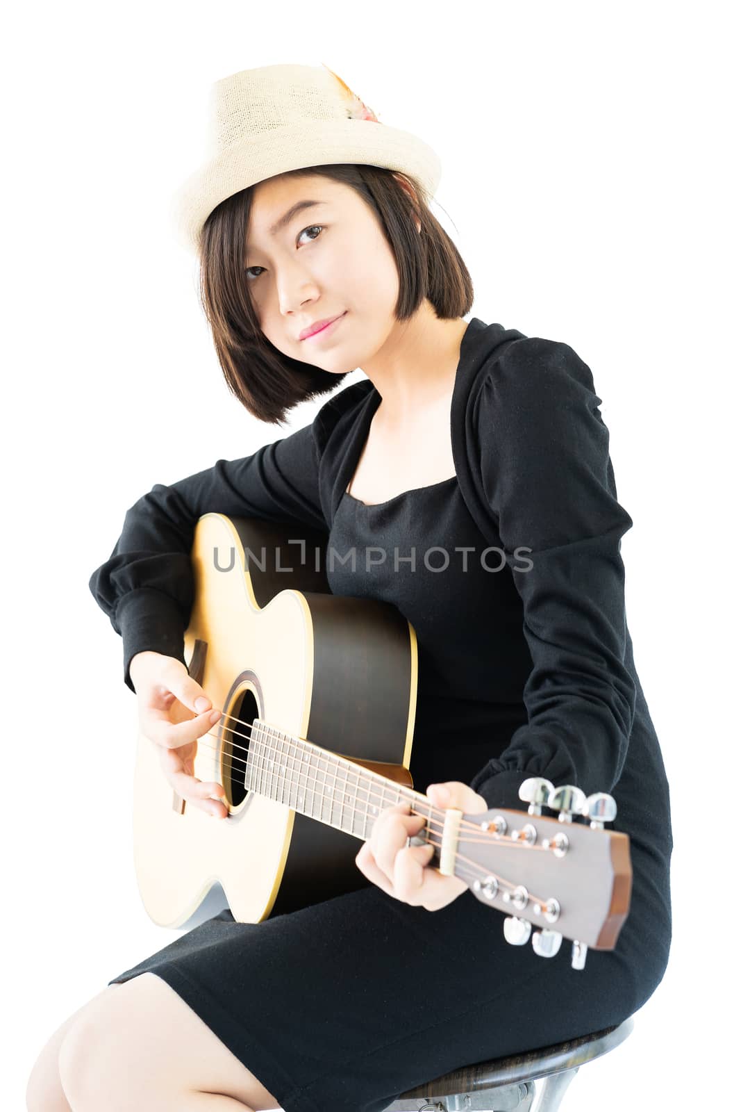 Woman sitting and playing guitar guitar folk song in her hand by stoonn
