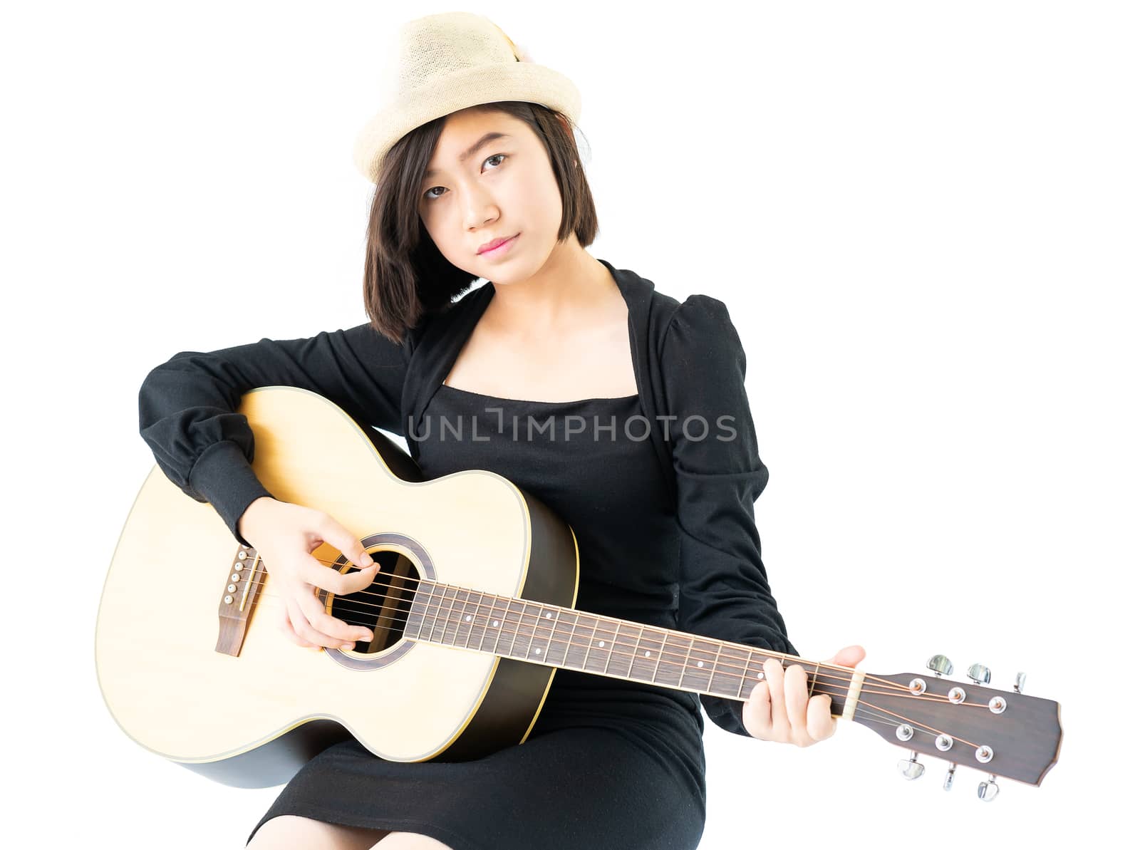 Young asia woman sitting and playing guitar guitar folk song in her hand isolate on white background