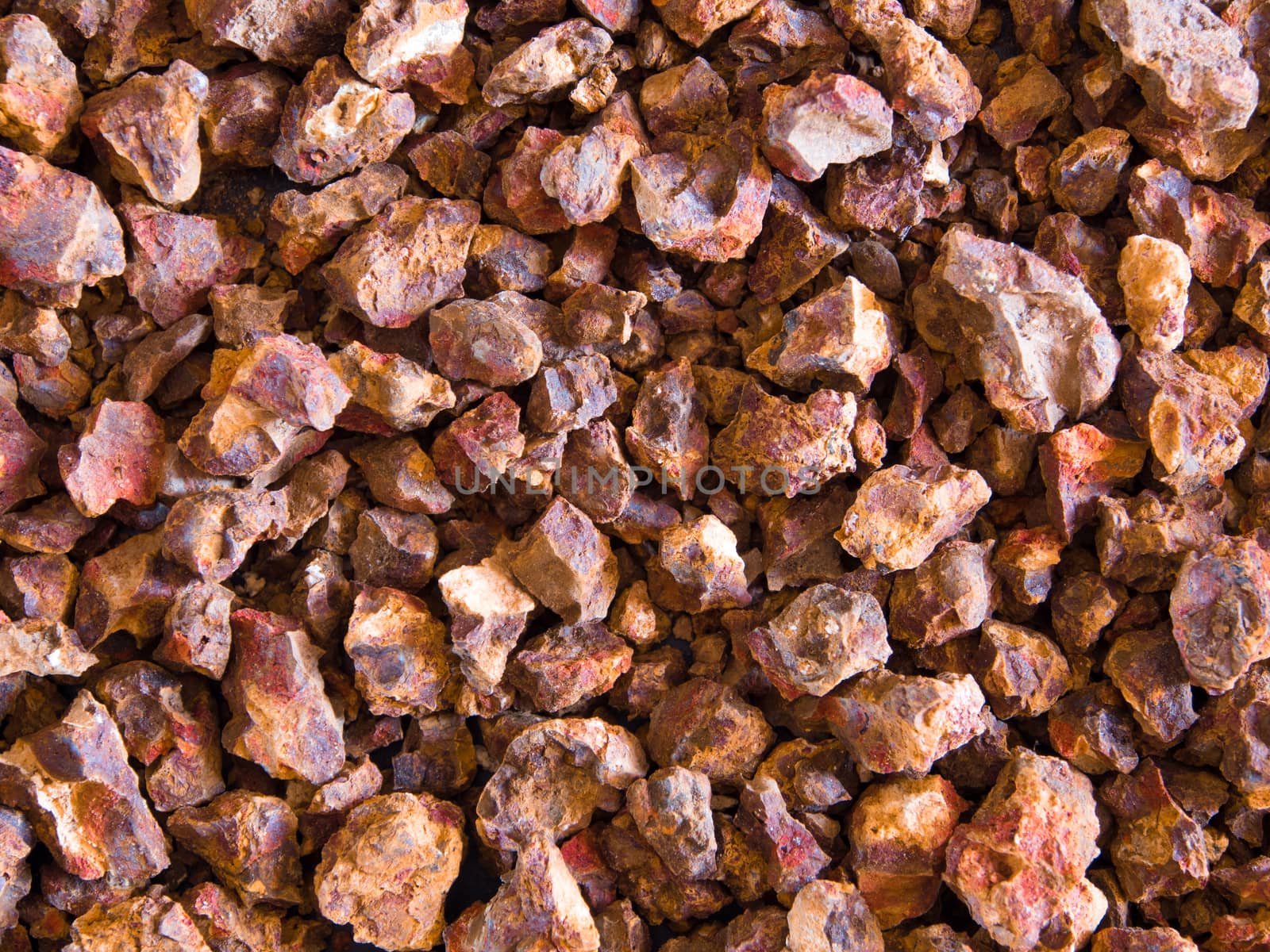 Red color of Iron oxide on gravel surface of broken laterite stone