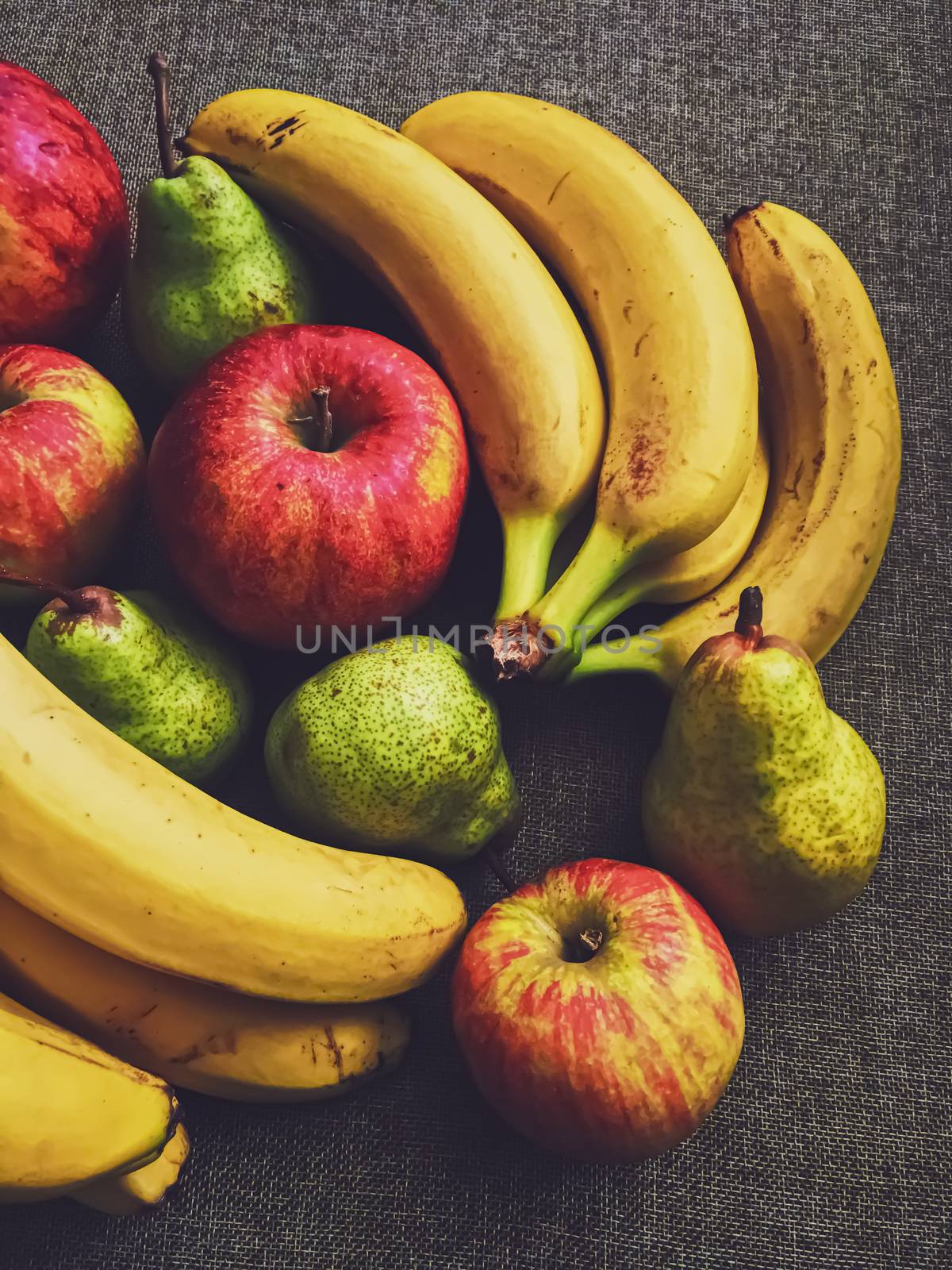 Organic apples, pears and bananas on rustic linen background, fruits farming and agriculture