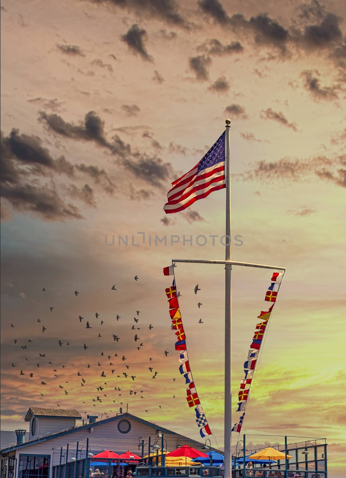 American and Nautical Flags at Sunset by dbvirago