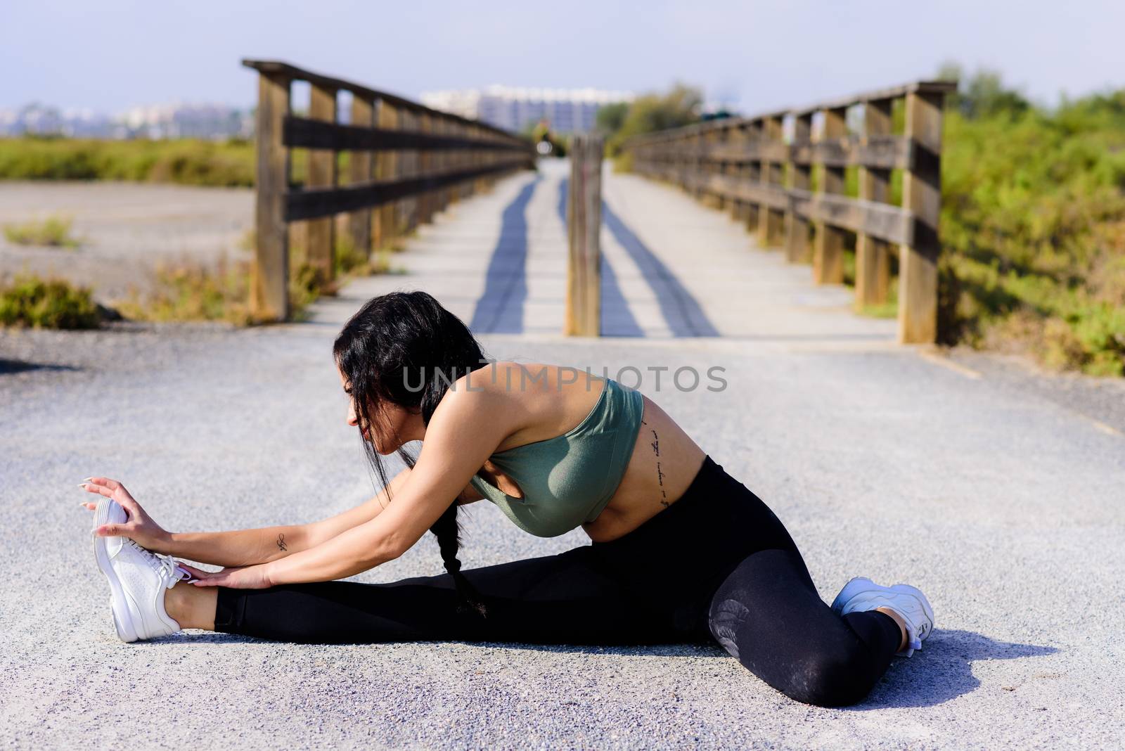 Strong woman doing push up at the beach.