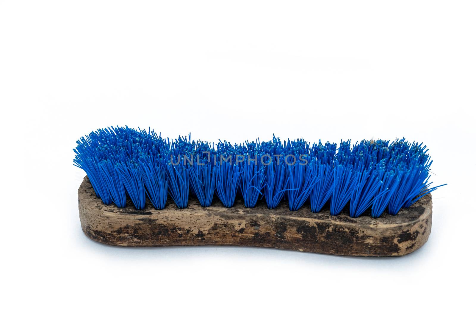 old Blue Washing brush with wooden handle on white background. by peerapixs
