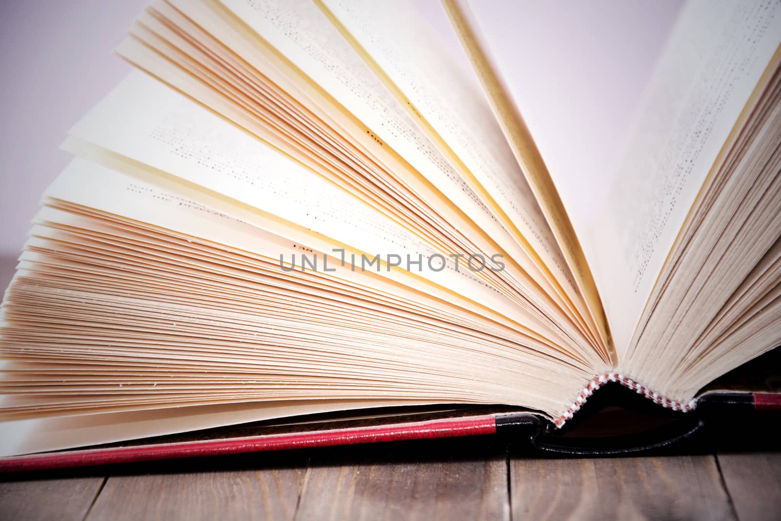 Open book on wooden table. by satariel