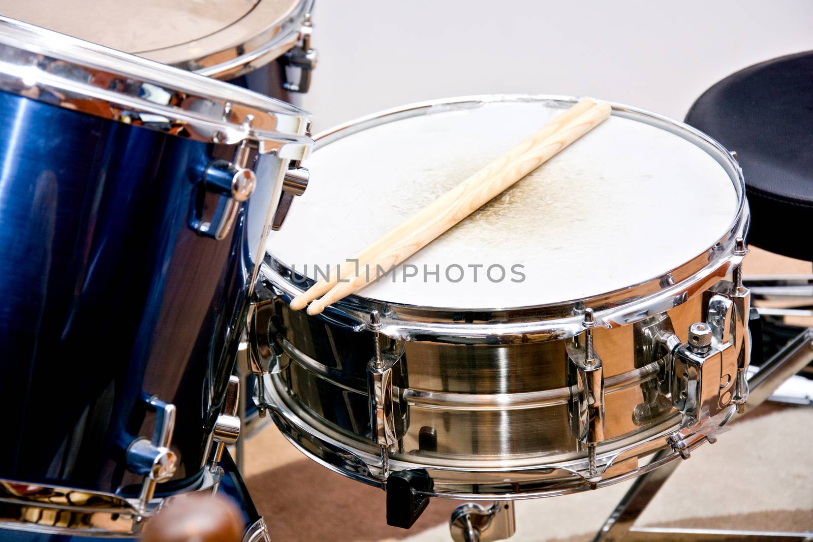 Drums conceptual image. Drumsticks lying on snare drum.