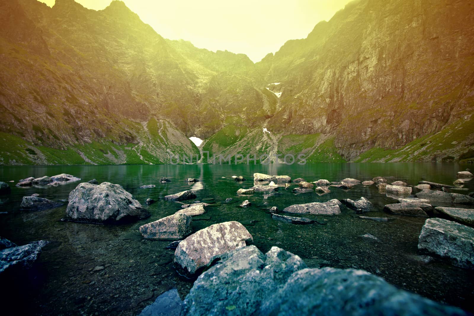 Sunset over lake in mountains. Nature concept.