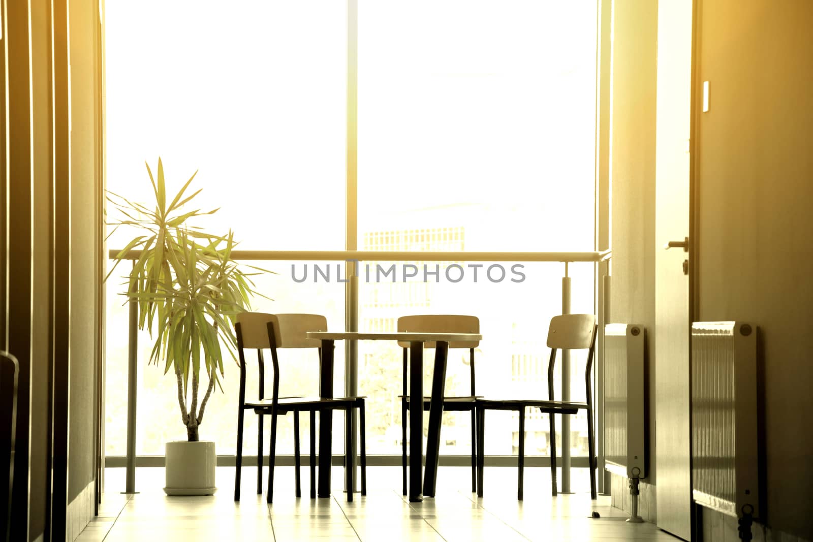 Bright sun in modern interior with table and chairs. Architecture concept.