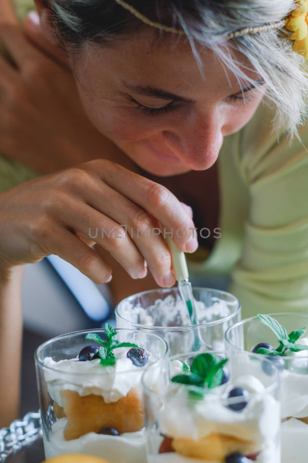 Close-up image of young lady eating dessert.