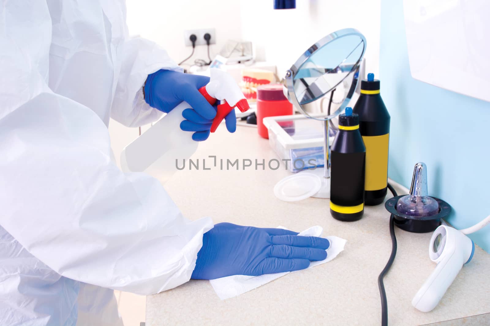 Doctor in protective suit uniform cleans the laboratory.  by satariel