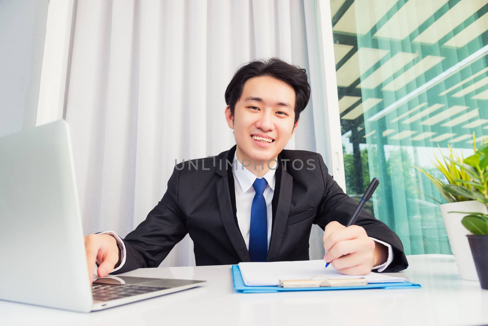 Businessman wearing suit video conference call laptop computer by Sorapop