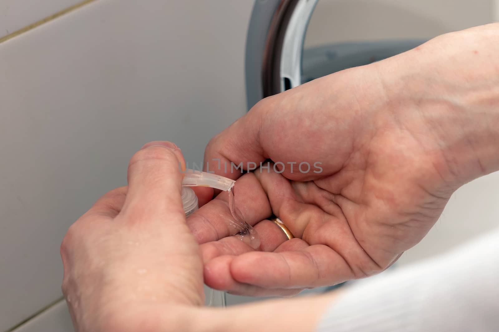 Man washing hands with soap and lathering suds. Protect against the coronavirus. by bonilook