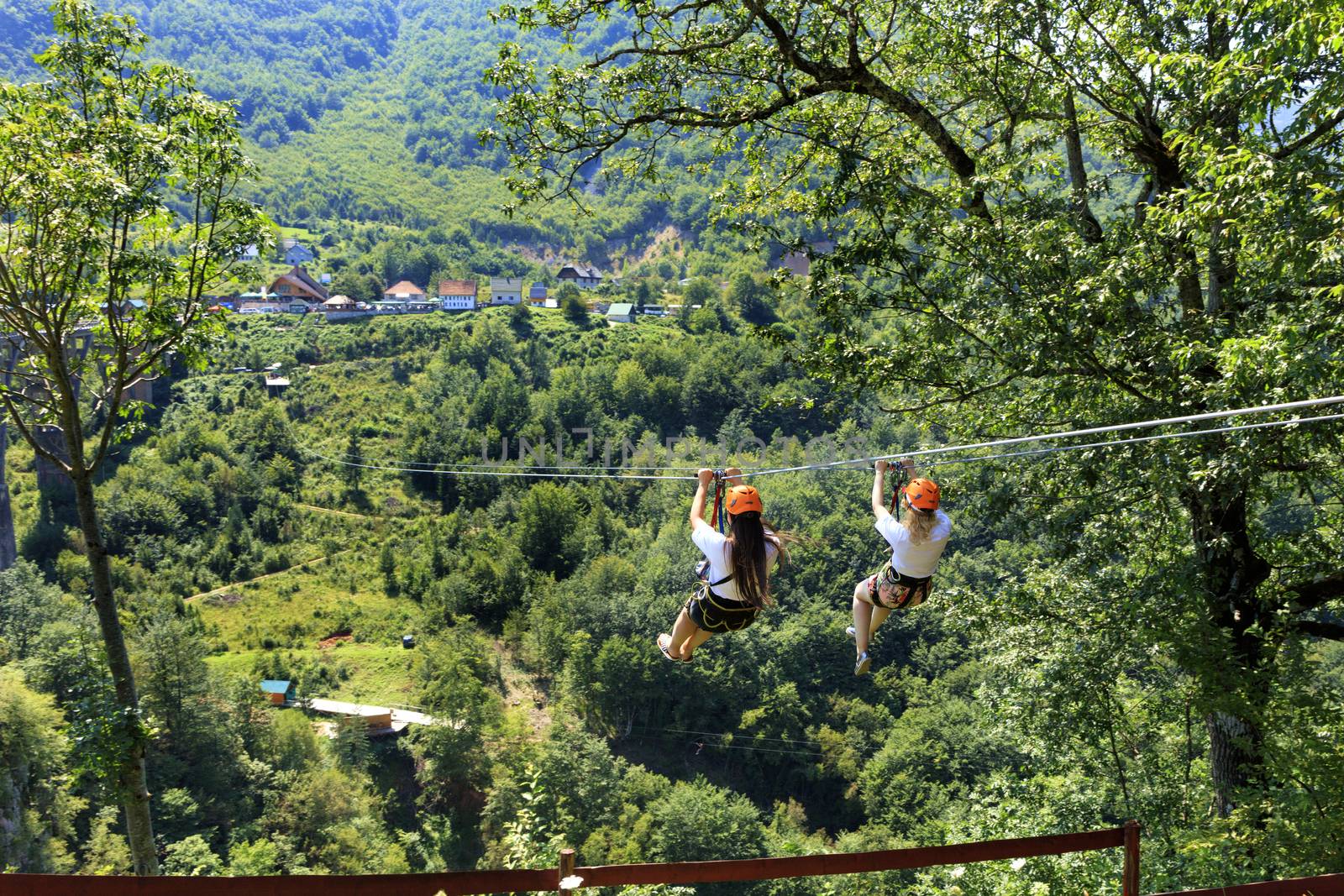 Girls on the cable car are sent through the mountain and the forest through the valley of the river Tiara in Montenegro.