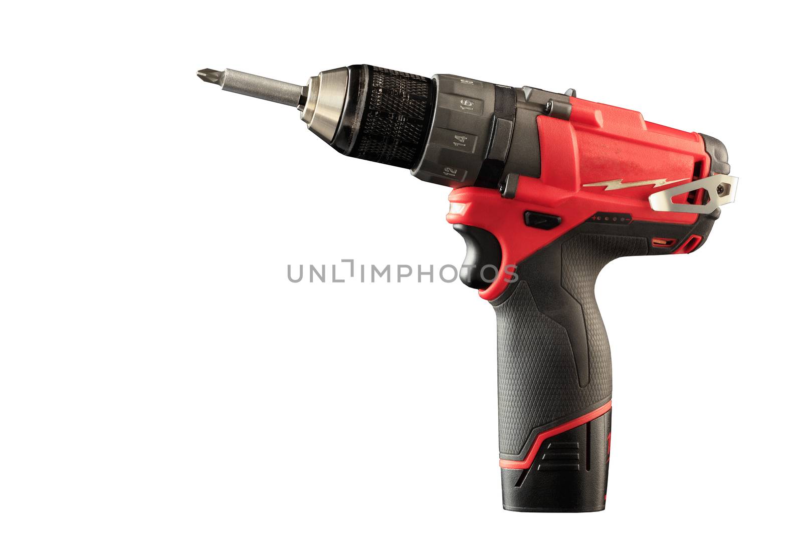 Cordless drill driver in red with rubberized handle in profile, isolated on white background