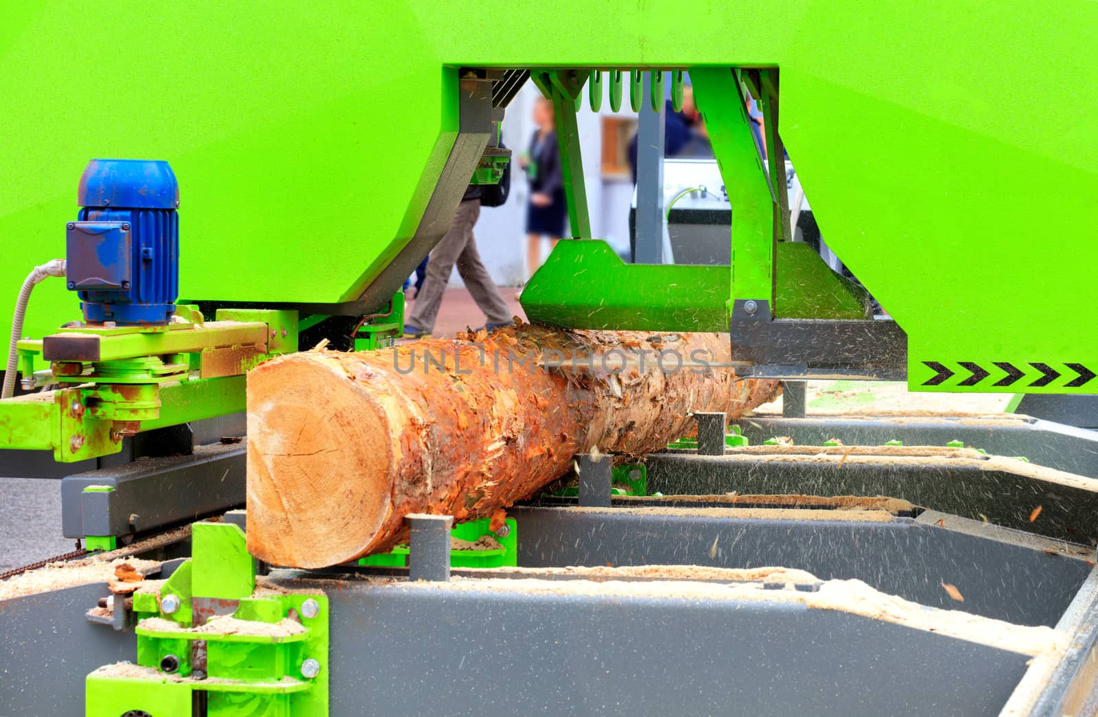 A large pine log is automatically quickly and accurately cut at a modern sawmill, receiving the necessary lumber.