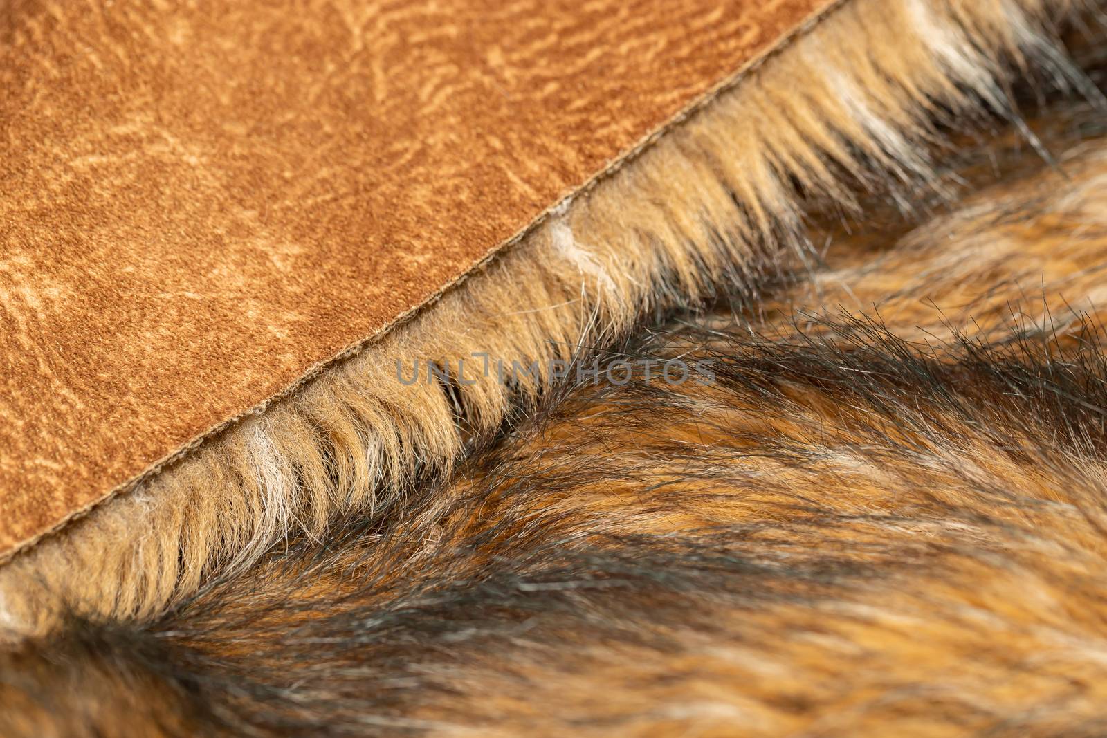 Close-up of a fluffy dark brown faux fur fabric with a background texture. by bonilook