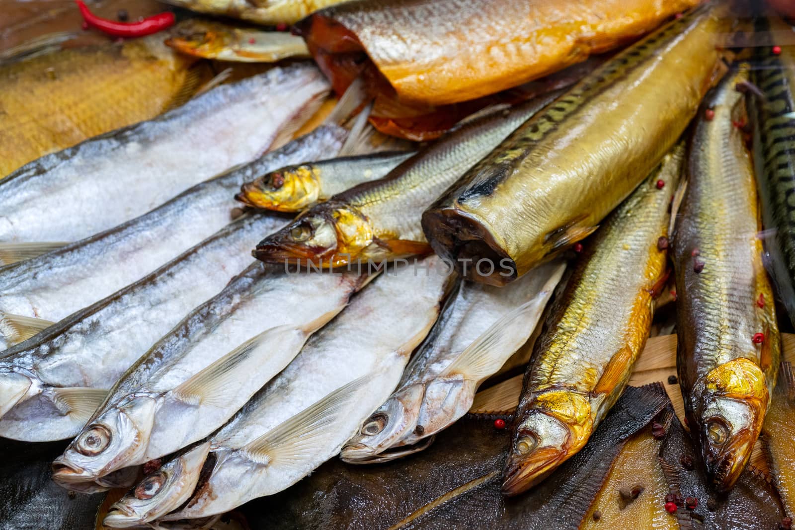 Smoked fish at the store counter. Seafood sale. Fish in shop window.