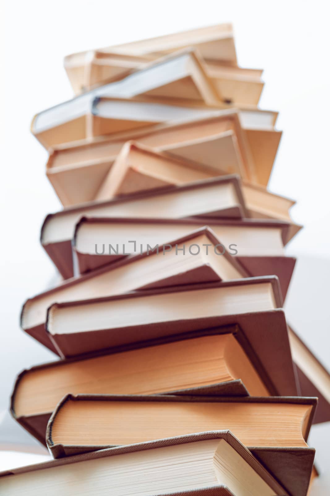 Stack of books in library. Scientific, educational, and fiction paper books. Education and training.