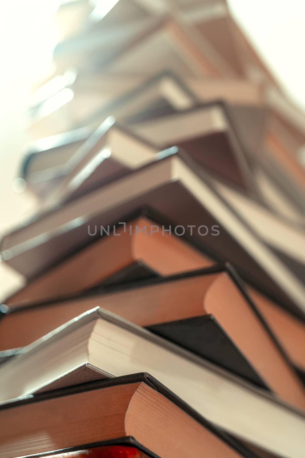 Stack of books in library. Scientific, educational, and fiction paper books. Education and training.