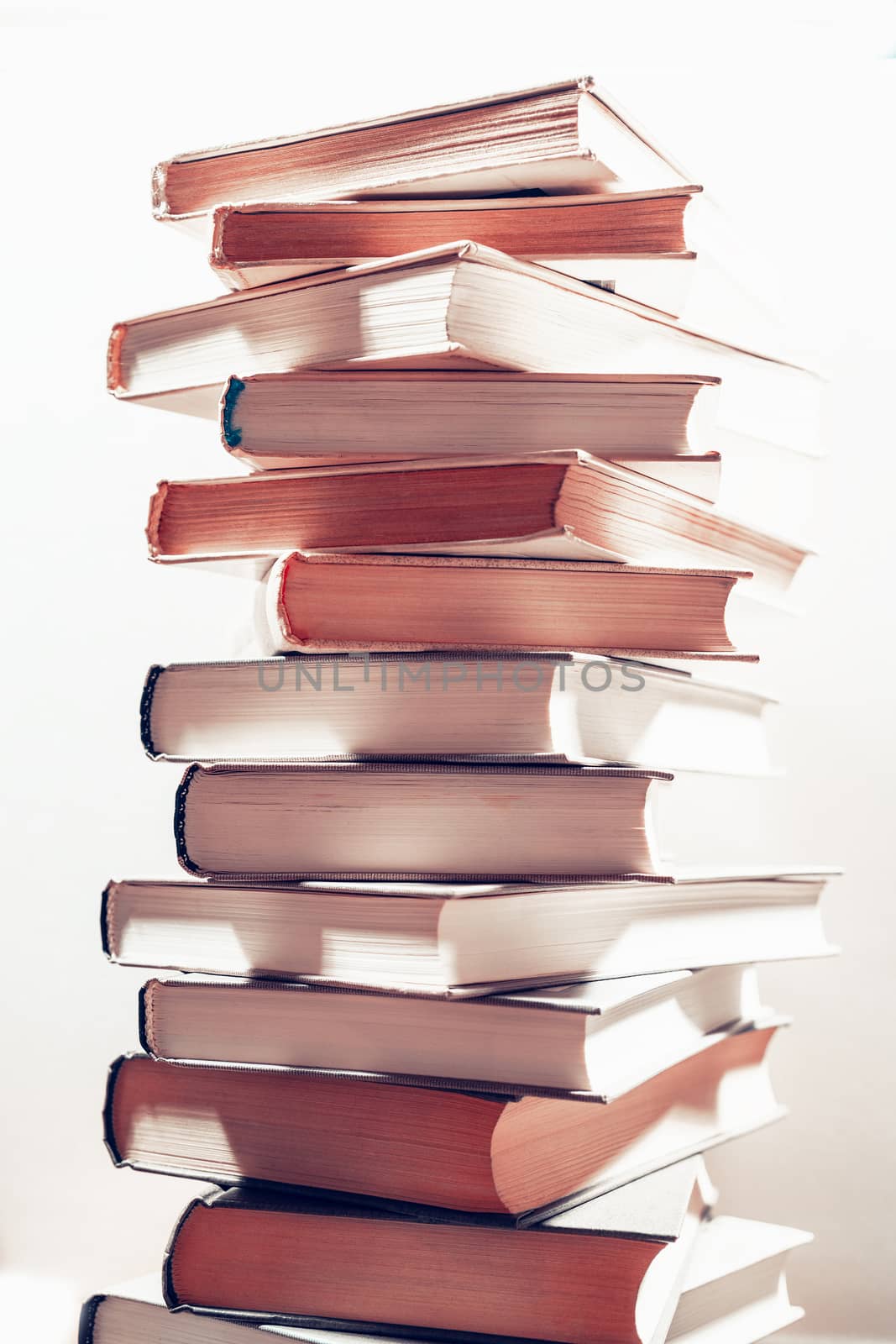 Stack of books in library. Scientific, educational, and fiction paper books. Education and training.
