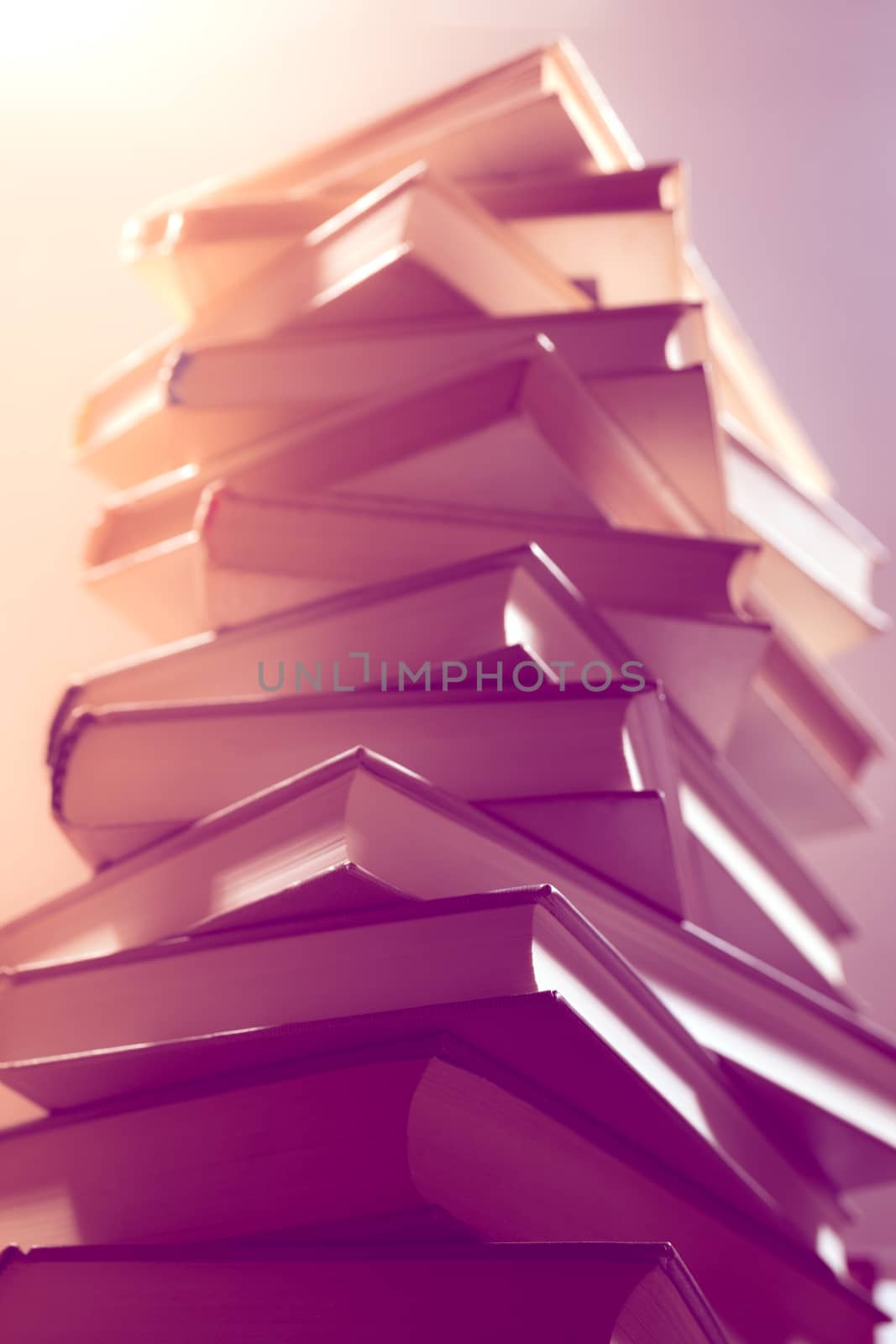 Stack of books in library. Scientific, educational, and fiction paper books. Education and training.