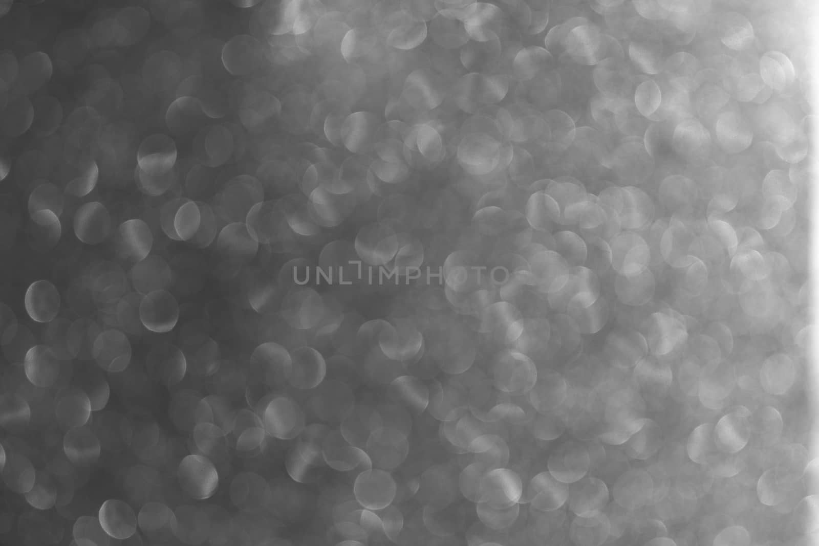 Gray Abstract beautiful bokeh background. Uneven dynamic background of the light effect of the lens.