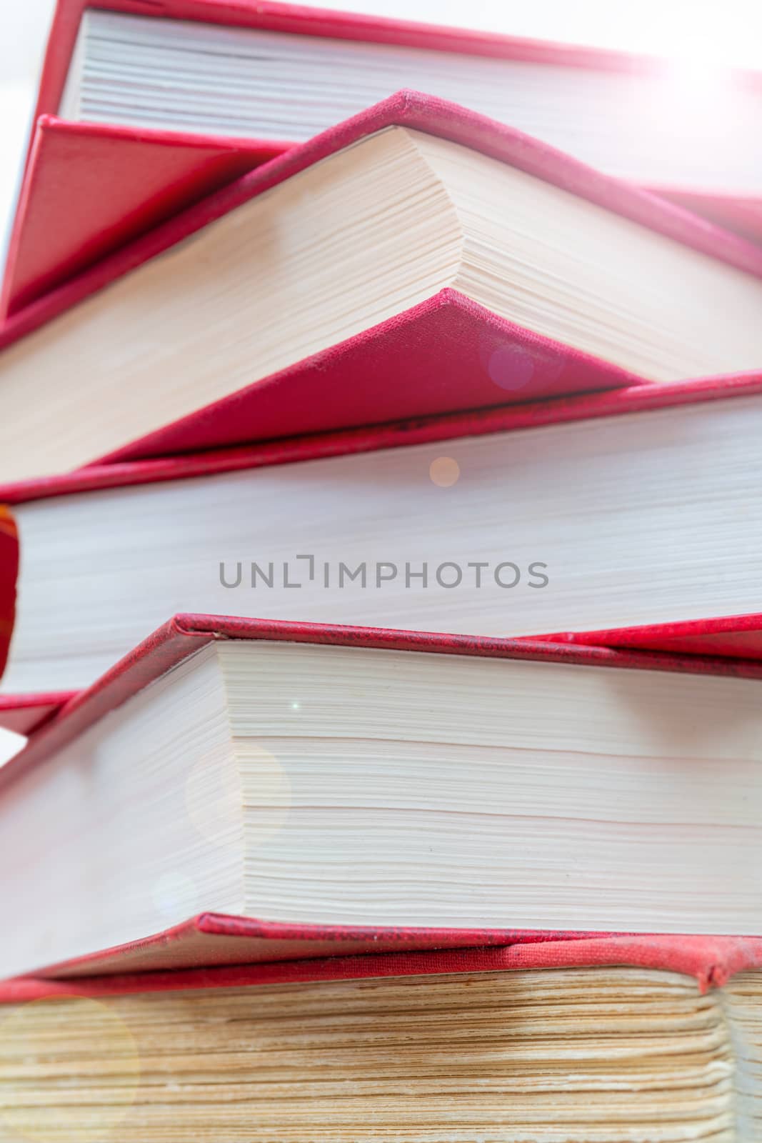 Pile of new books. Books in red covers. Training and education on the pages of books.