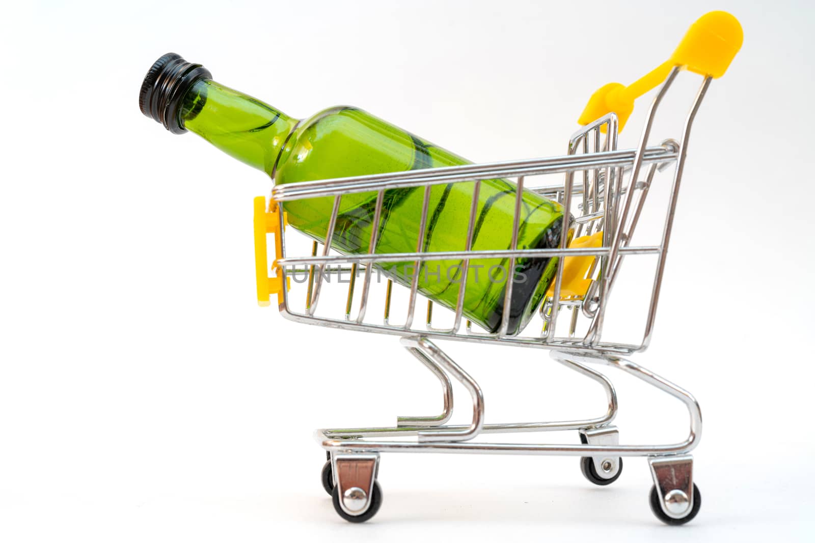 Selling alcohol in a store. Green bottle in a supermarket cart. Drink in a green bottle.