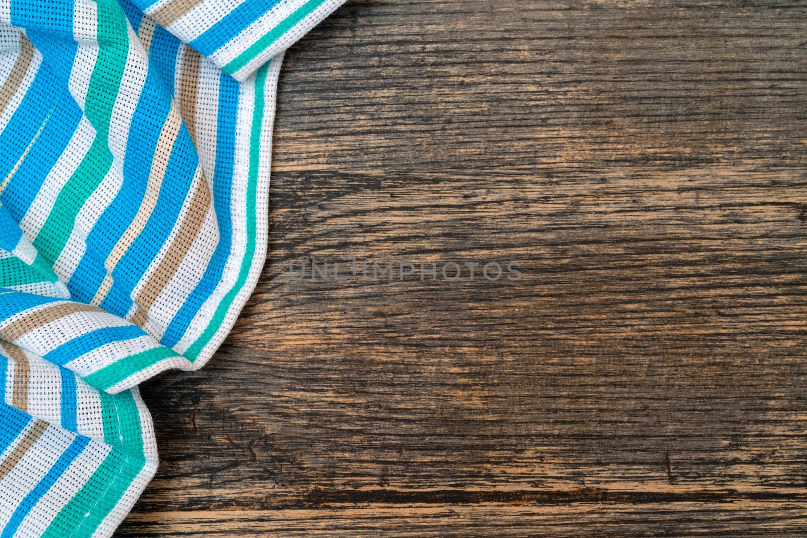 Blue checkered towel on the kitchen table. Wooden kitchen table.