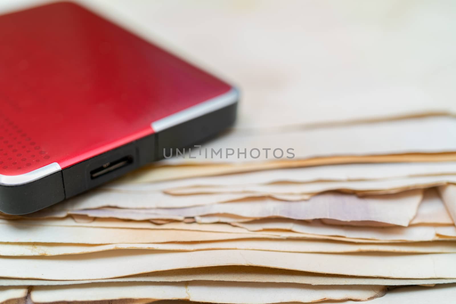 Hard drive for storing information. Stack of vintage paper. Old yellow sheets of paper. Yellow pages of the book.