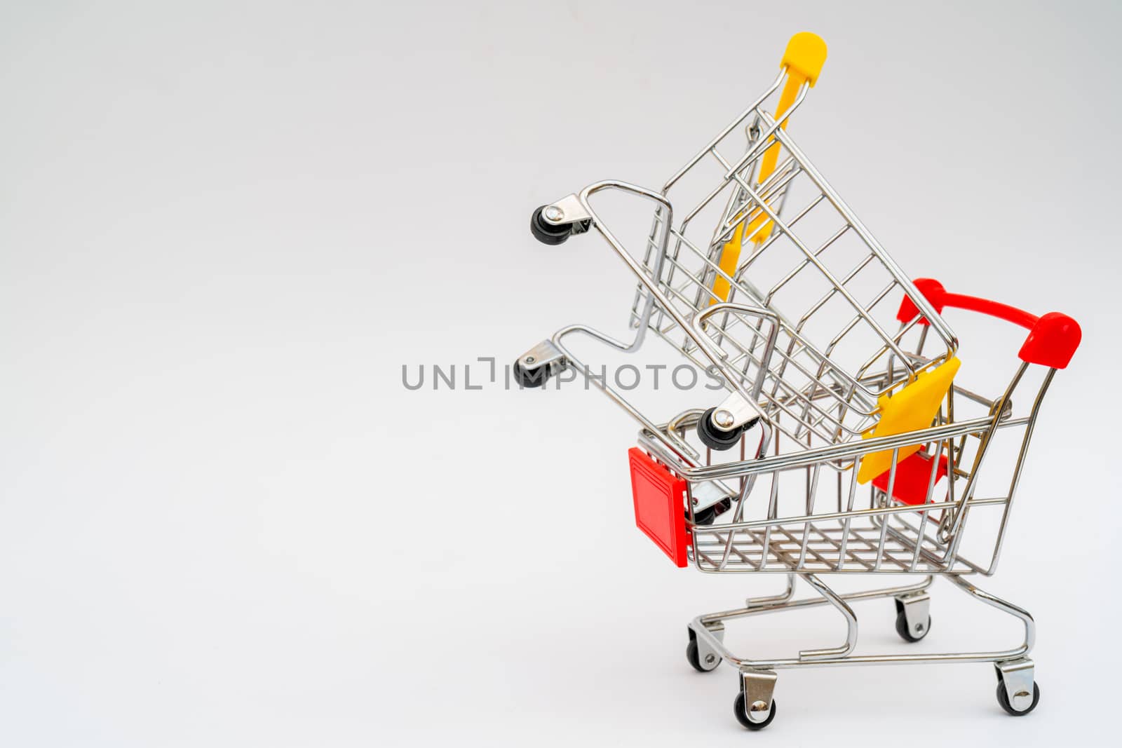 Metal trolley for supermarket. Transportation of products in store. Retail.