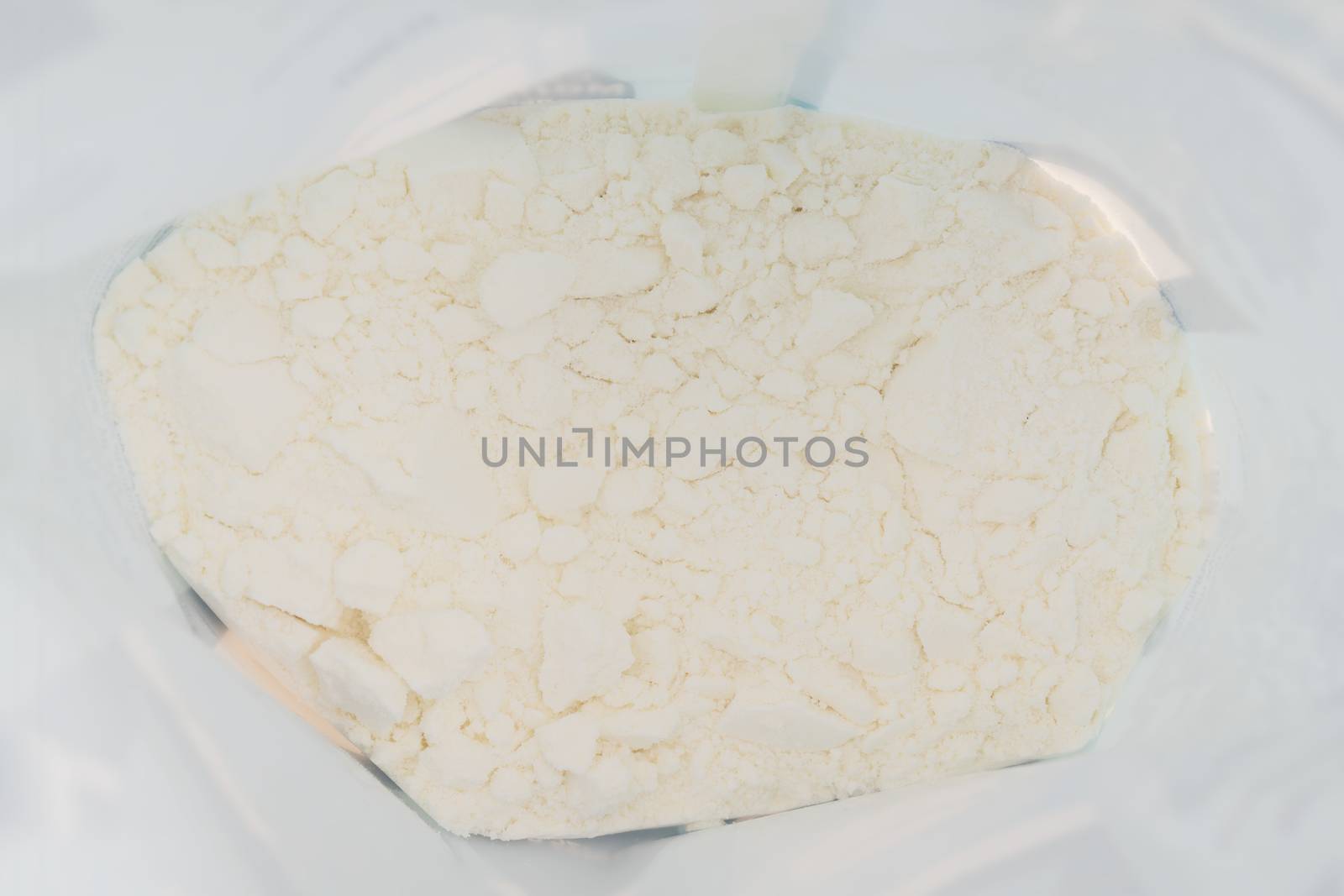 Powdered milk. White abstract texture. Light uneven rough background.