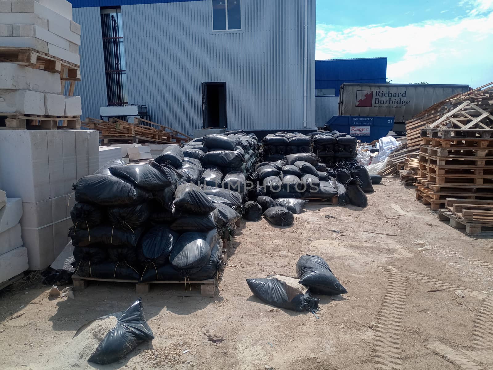 Packages with rubble and sand on the construction site. Building materials base.