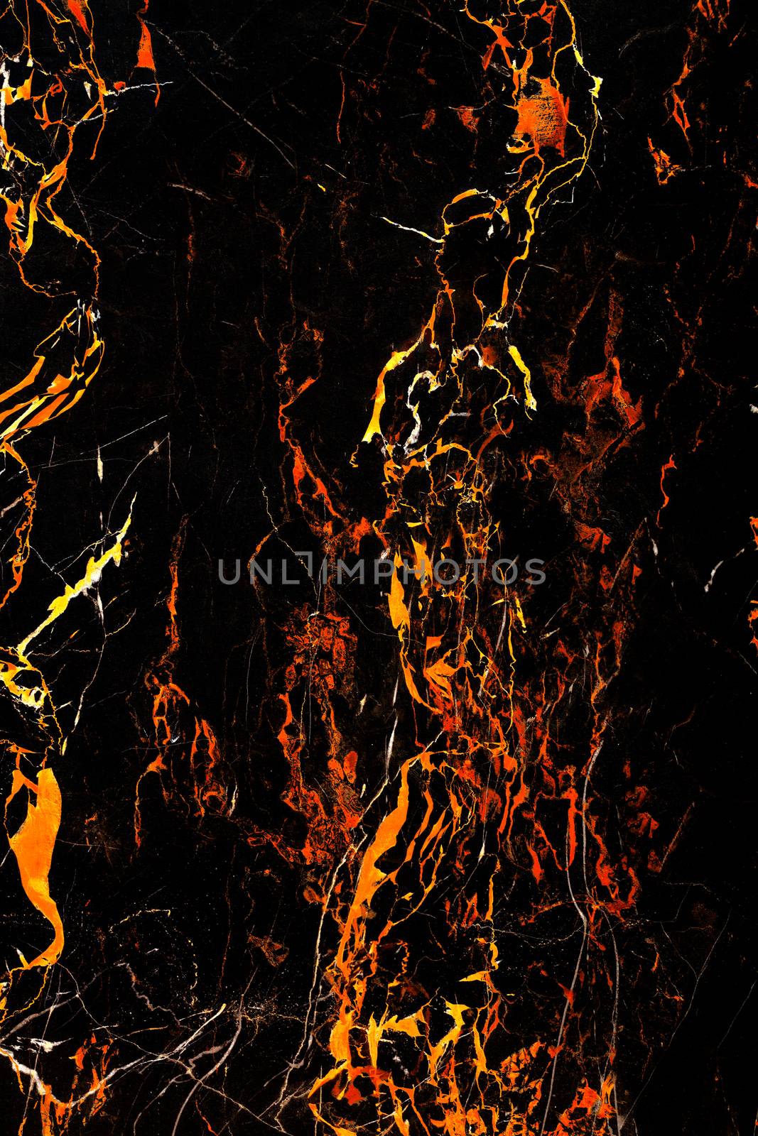 Marble spots, like frozen lava flows on a black marble surface. Black and fiery marble texture.