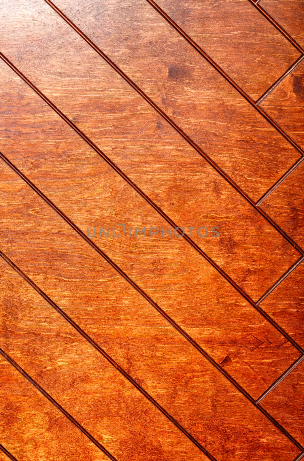 Rectangular boards are painted in orange and neatly laid out with a herringbone pattern, vertical image.