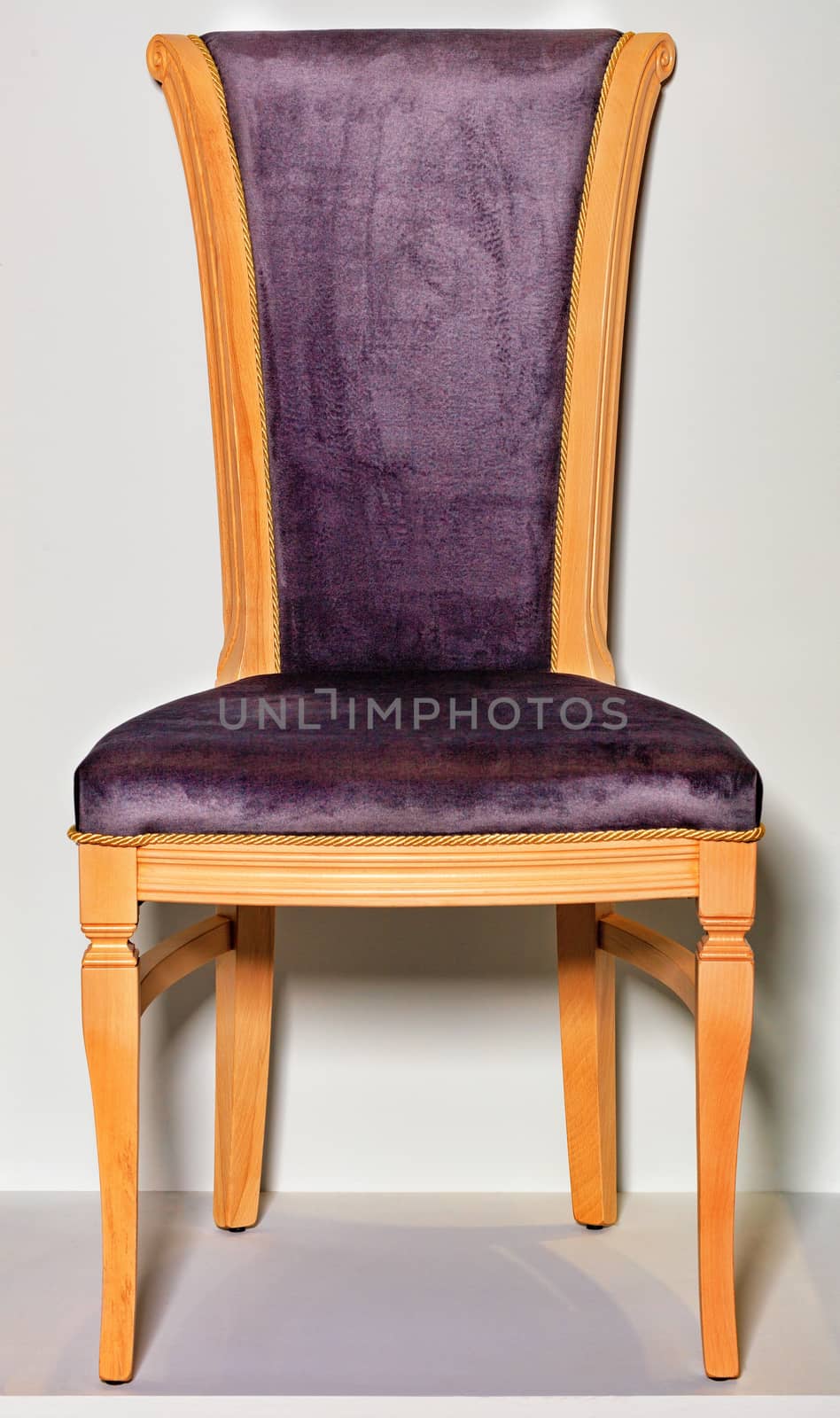 Wooden chair with a soft saddle and back on a gray podium and background. by Sergii