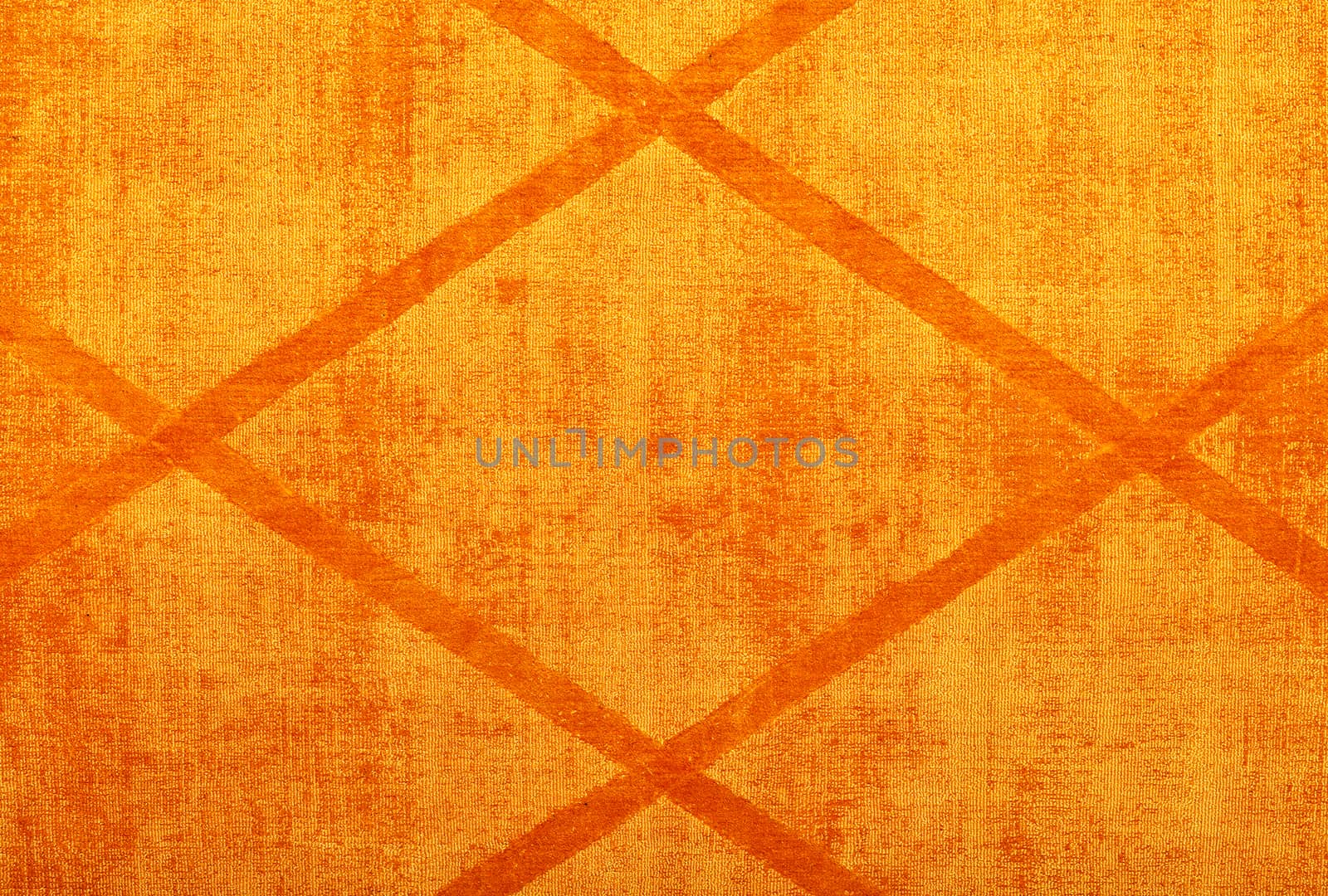 The texture of the textile cotton fabric and the surface is bright orange with a symmetrical rhombic pattern.