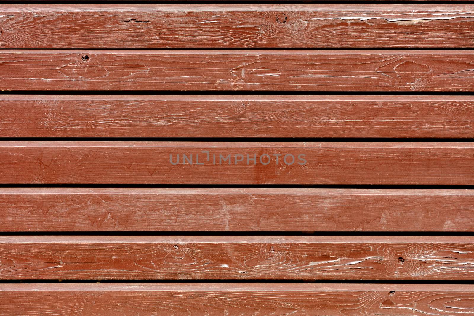 Brown old paint on an eroded shabby wooden horizontal wooden battens, texture of an old wood.