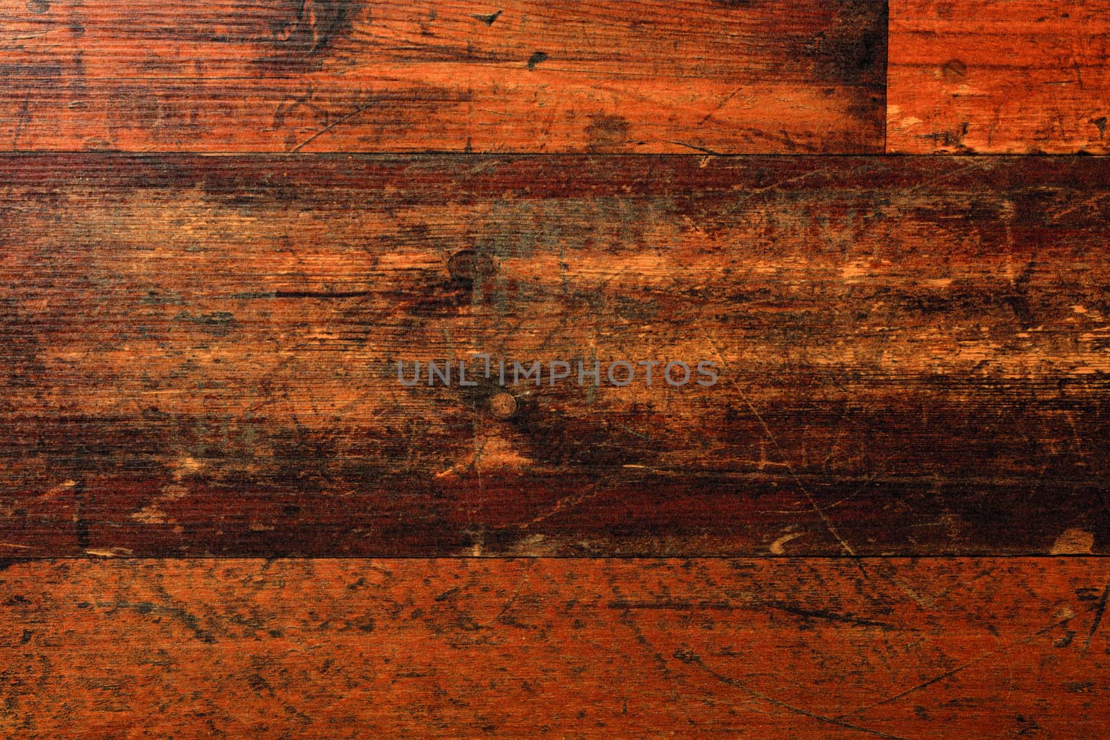 The beautiful texture of natural floorboards, worn and scratched over many years of use, with cracks, stains and a horizontal pattern of fibers.