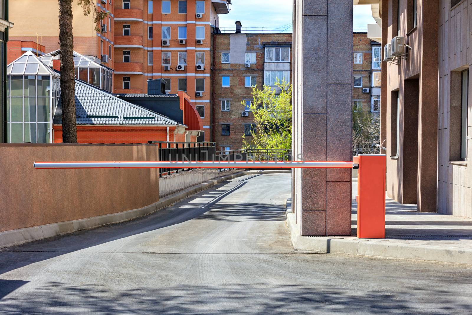 Automatic barrier to enter the courtyard of a residential building. by Sergii
