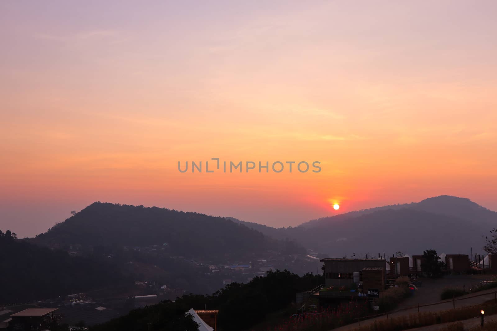 Colorful sunset over the mountain hills in a thai village near mountains in Chiang Mai, Thailand. The mountain scenery view