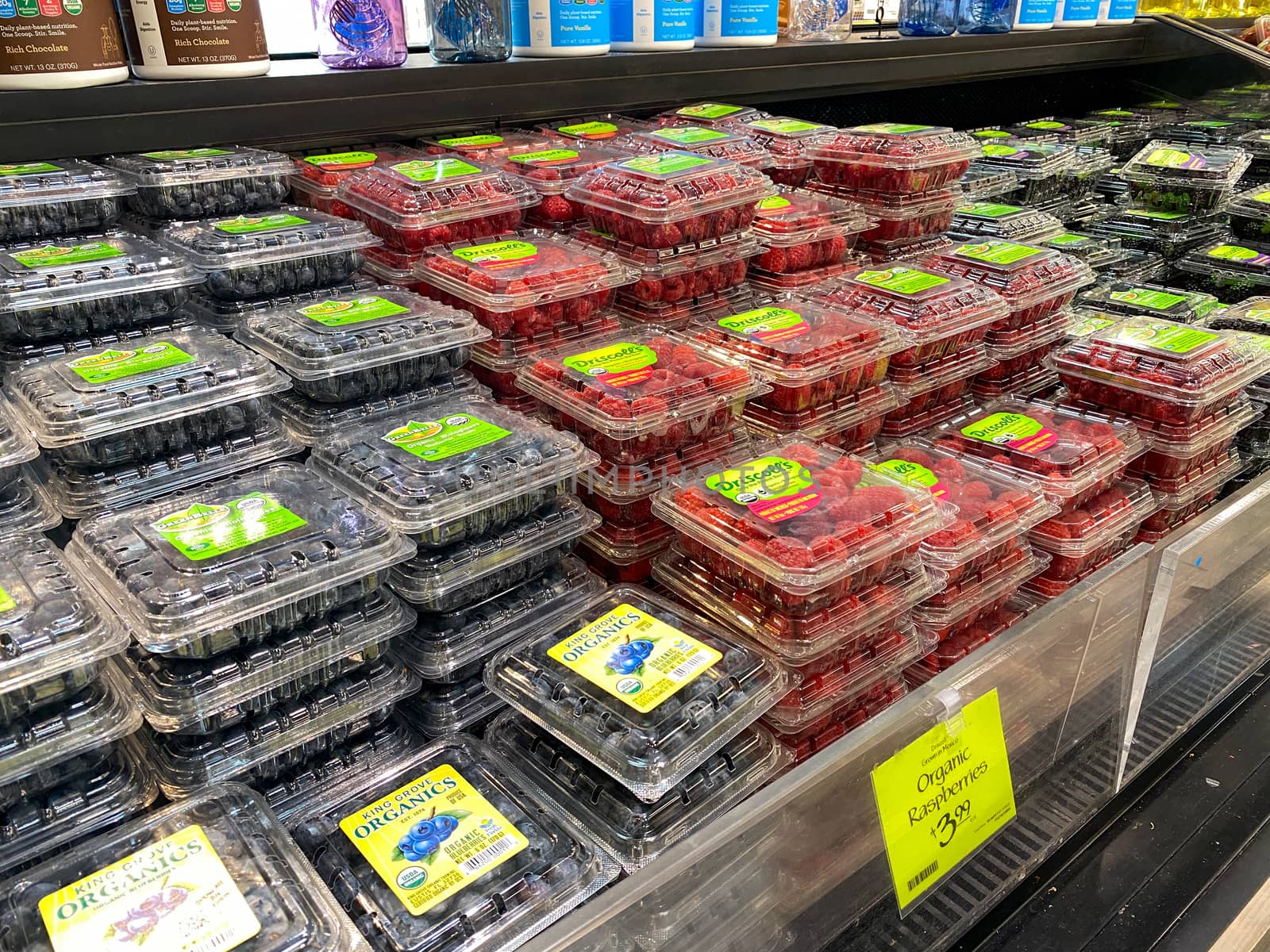 Orlando,FL/USA -5/10/20:  Boxes of raspberries and blueberrie at the fresh produce aisle of a Whole Foods Market grocery store.