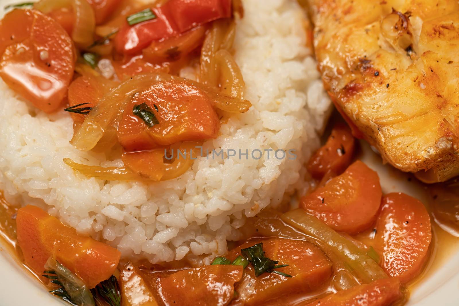 Fish is baked in the oven with onions and carrot slices and served with a side dish of rice. Flexitarian Diet Concept