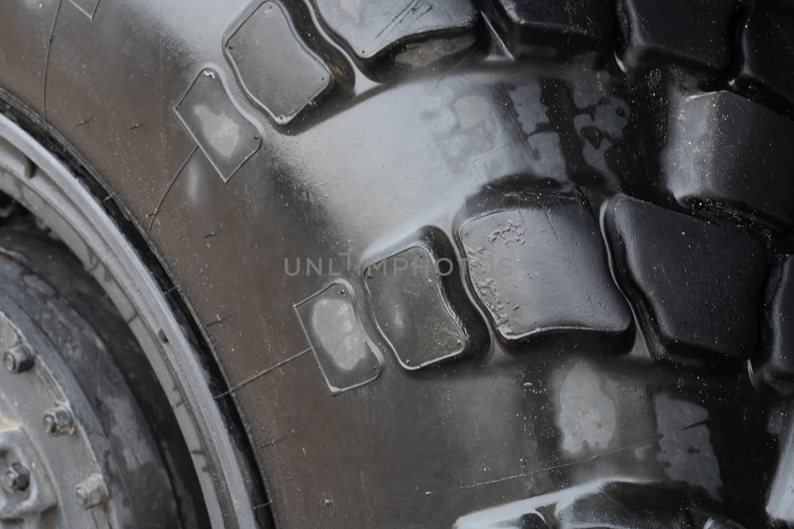 dark rough rubber truck tire, fragment