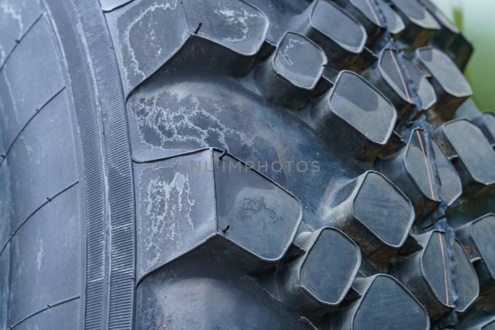 dark rough rubber truck tire, fragment