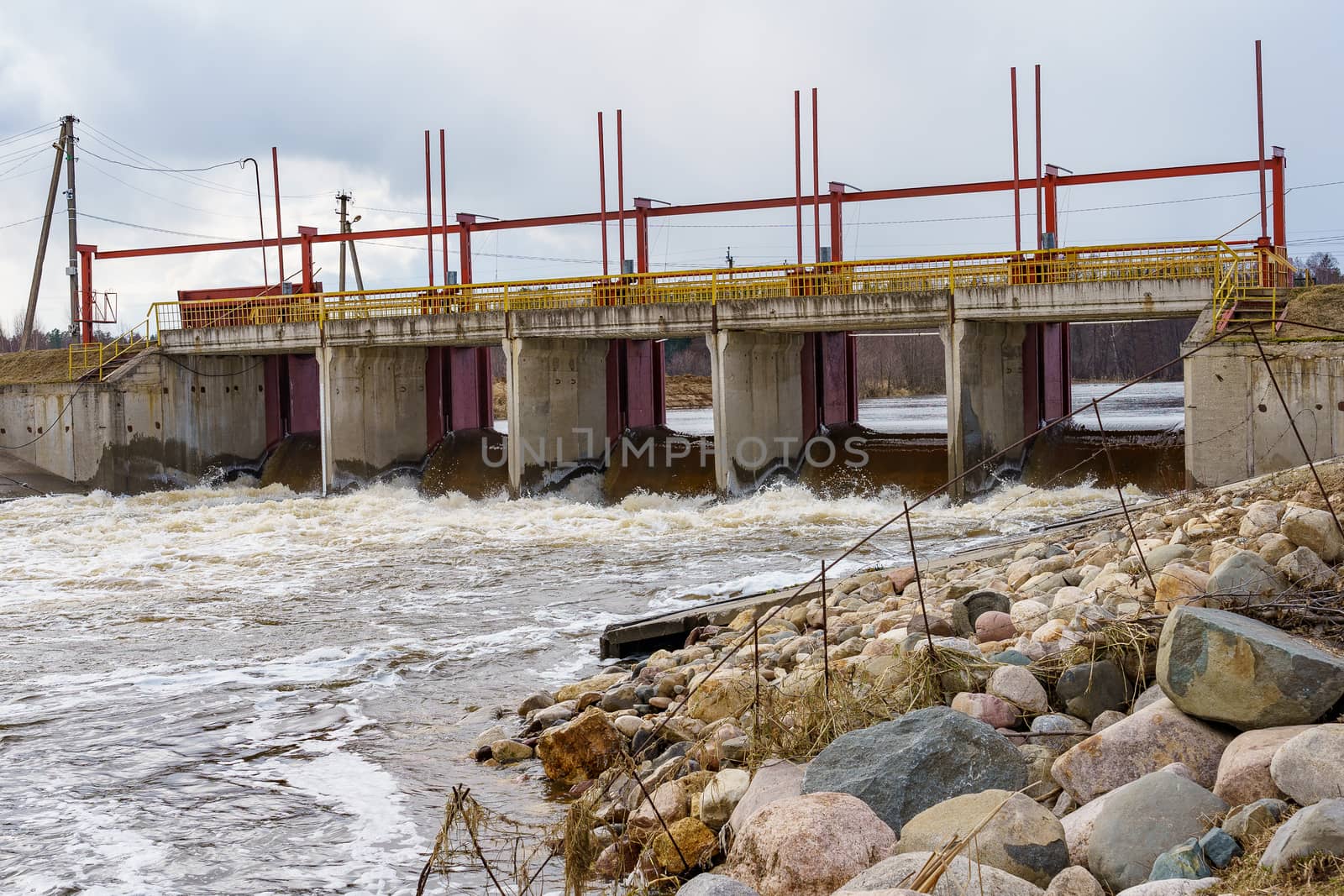 hydraulic structure, a dam through which a river flows, made of concrete and metal