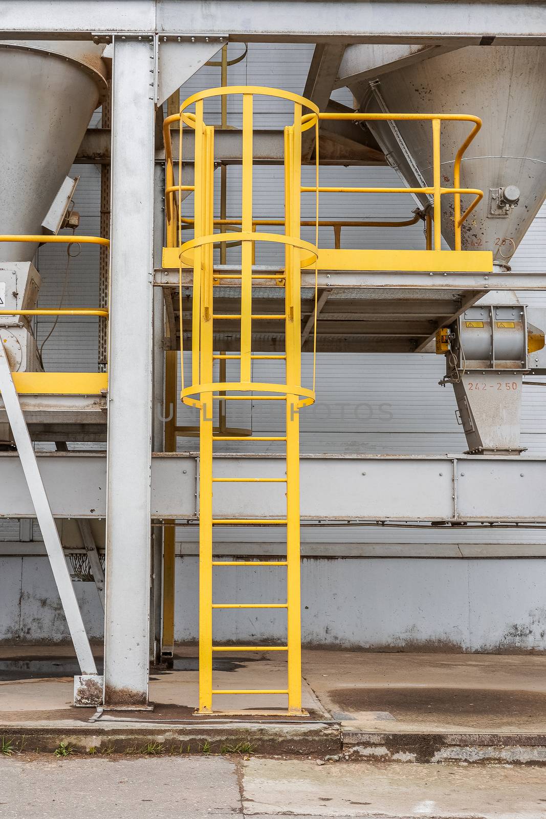 fire safety elements on the wall of an industrial building: stairs, fences