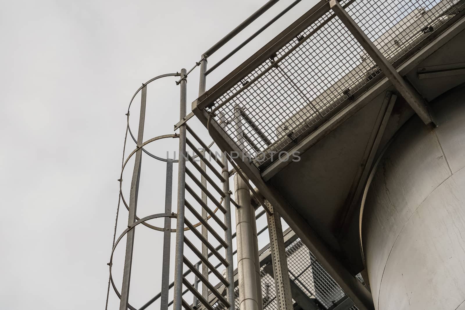 upper part of an industrial building with stairs, railings and other safety features