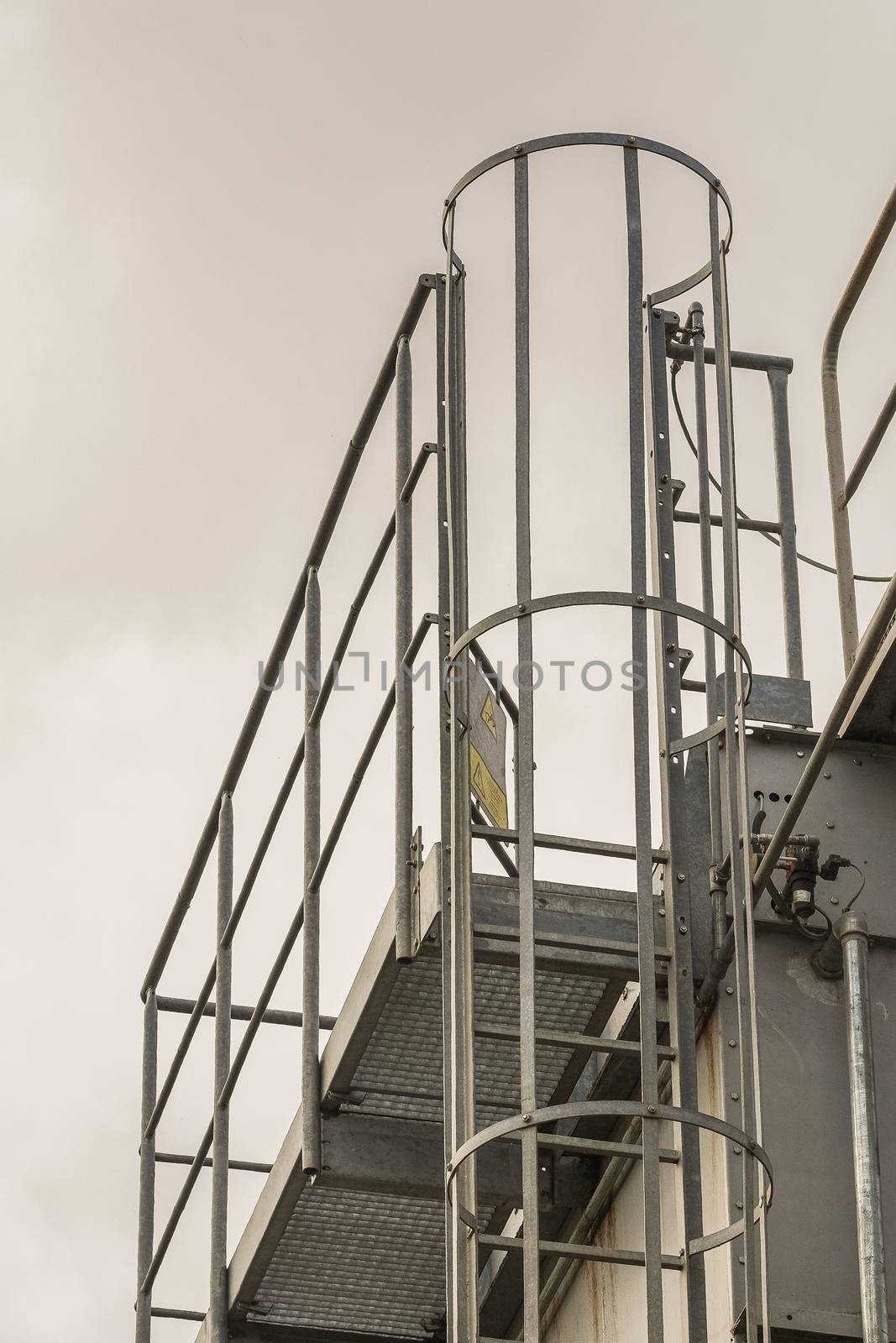 upper part of an industrial building with stairs, railings and other safety features