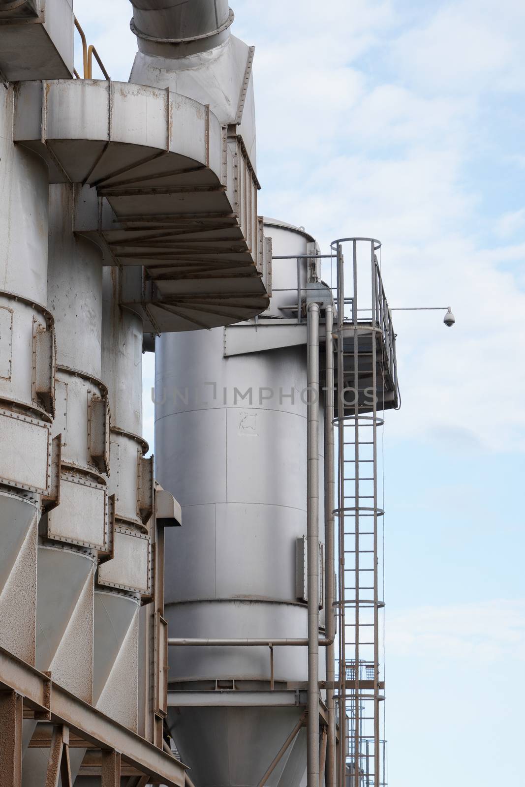 upper part of an industrial building with stairs, railings and other safety features